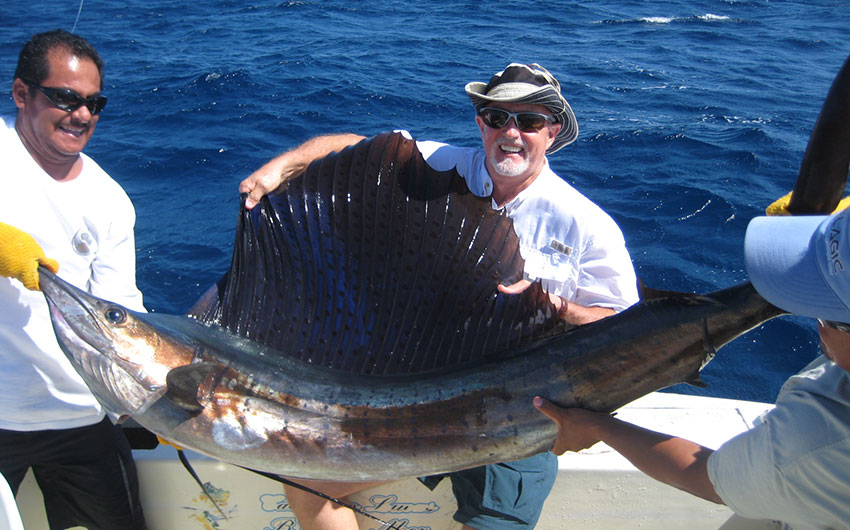 Winemaker Terry Dean Walker holding blue marlin fish he just caught